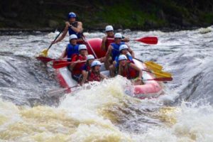 An image of a group of people going down the rapids in a raft.