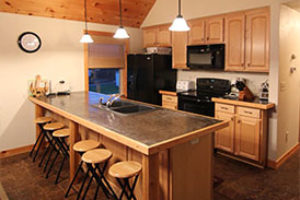 An image of a kitchen with a dining counter.