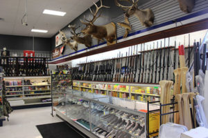 An image of a gun shop with game mounts on the wall.