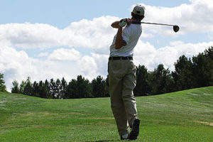 An image of a golfer at the end of his swing.