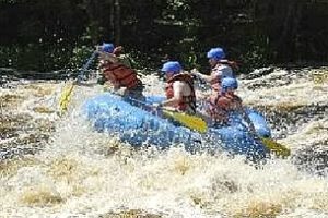 An image of water splashing a group in a raft.