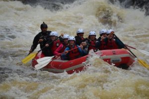 An image of a group of people white water rafting.