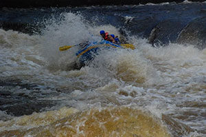 An image of a group of people white water rafting.