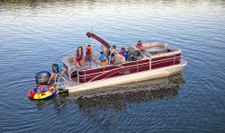 A picture of a family on a pontoon boat in the water.
