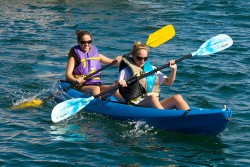A picture of two girls kayaking.