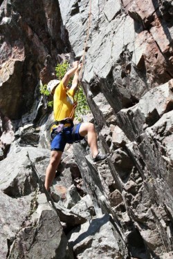 A picture of a person rock climbing.
