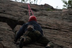 A picture of a person climbing a rock wall.