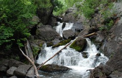 A picture of a river cascading down rock walls.